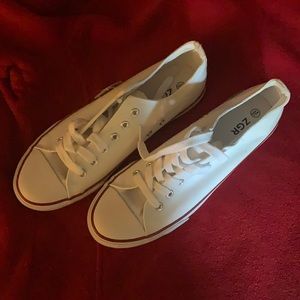 Women’s white sneakers with red and blue outlines